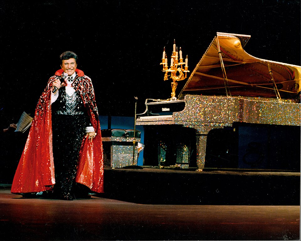 Scope and content:  The original finding aid described this photograph as:
Original Caption: Rhinestones glitter in the background as Liberace performs.
Location: Las Vegas, Nevada (36.126° N 115.166° W)

Status: Public domain. Courtesy of The Liberace Foundation and Museum